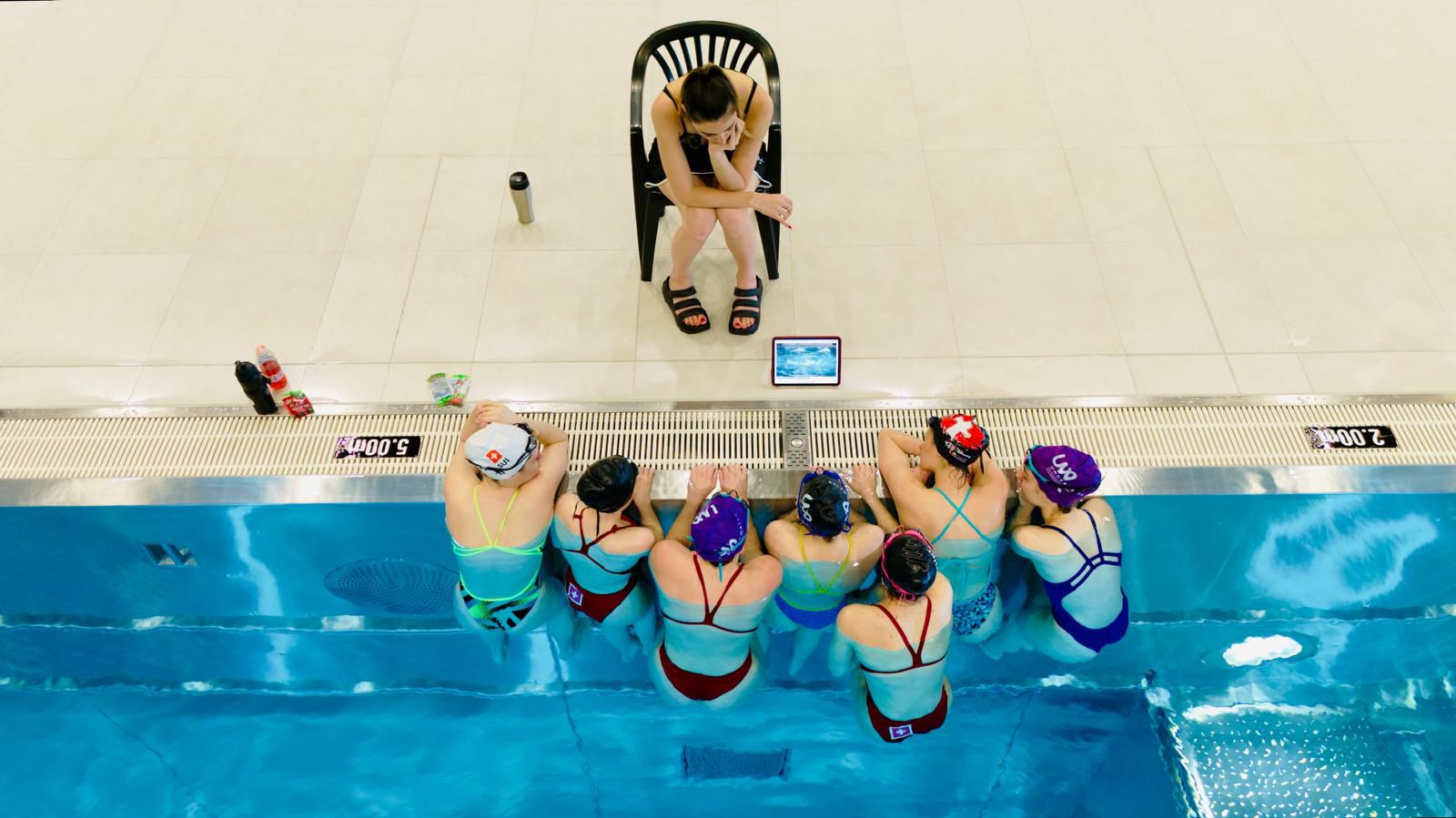Vue aérienne, coach en briefing avec son équipe alignée au bord